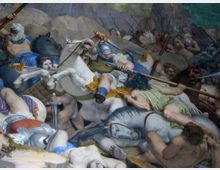 Affresco o dipinto murale storico che raffigura una scena di battaglia con cavalieri, cavalli e lance in primo piano, in un paesaggio roccioso sullo sfondo. La composizione è affollata e dinamica, con armature e armi evidenziate tra figure sovrapposte.